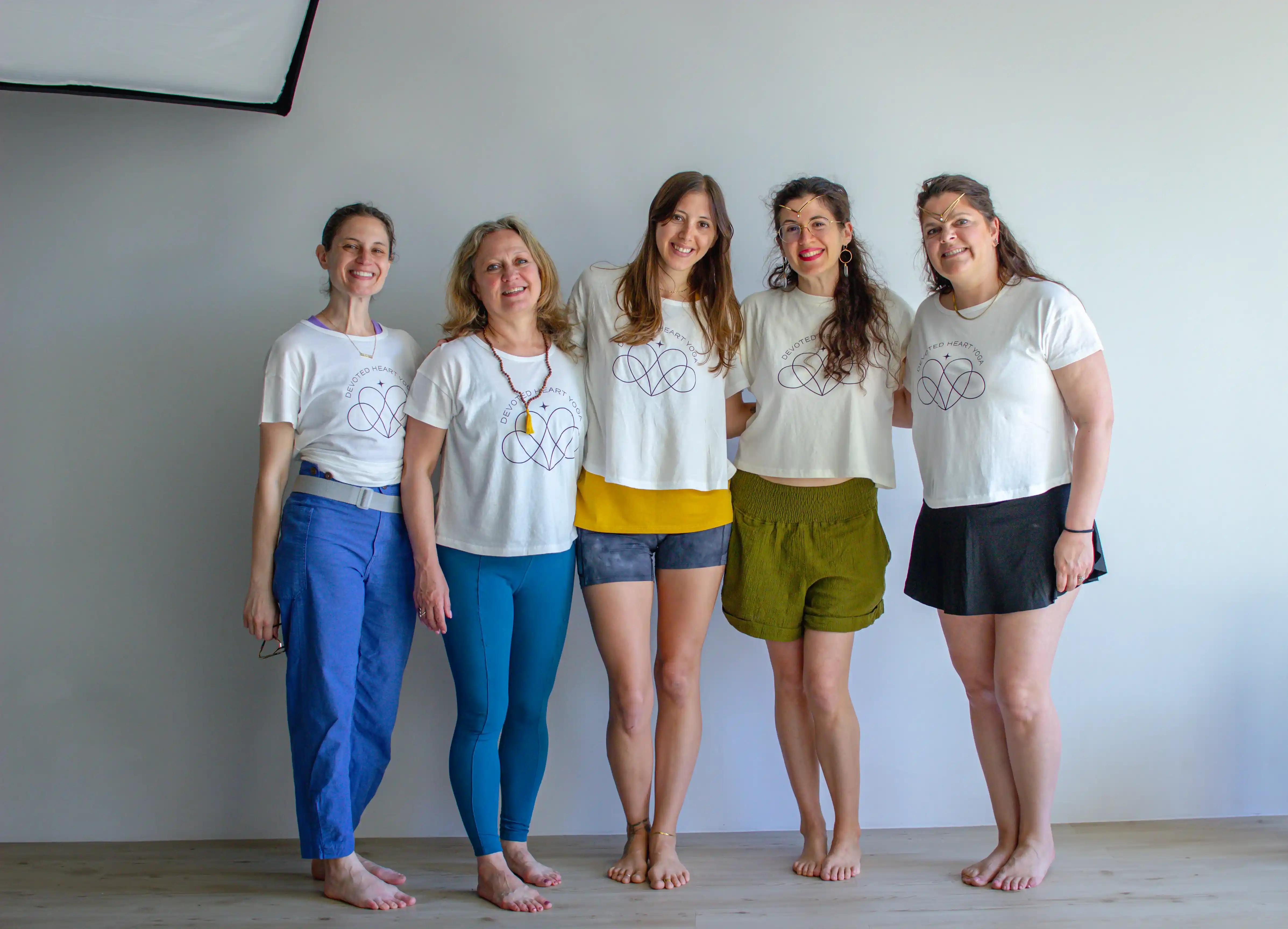 Students practicing yoga together in a sunlit boutique studio
